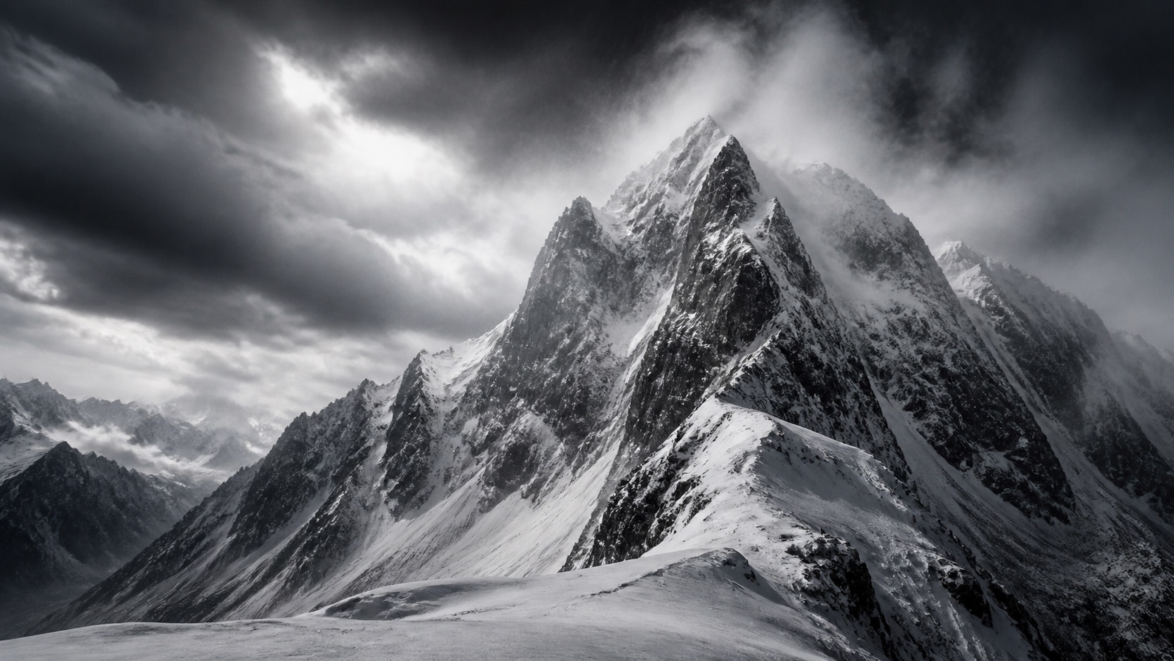 Snow-covered Alpine mountain ridge beneath dramatic winter clouds